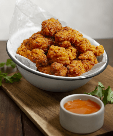 Paneer Tikka Masala Recipe | Restaurant-Style Indian Curry being poured into a wooden bowl