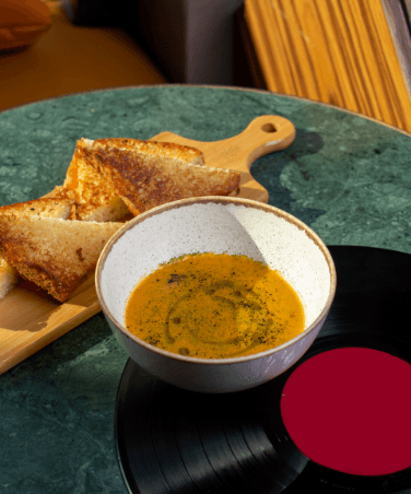Samosa Recipe | Easy Indian Samosa with Jhakash Tikka Sauce being poured into a wooden bowl
