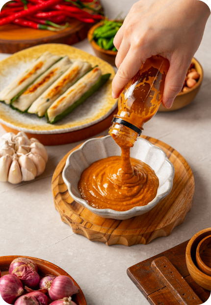 Tikka Sauce being poured into a wooden bowl